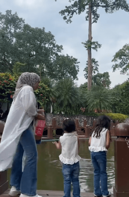 Feeding fish with her kid