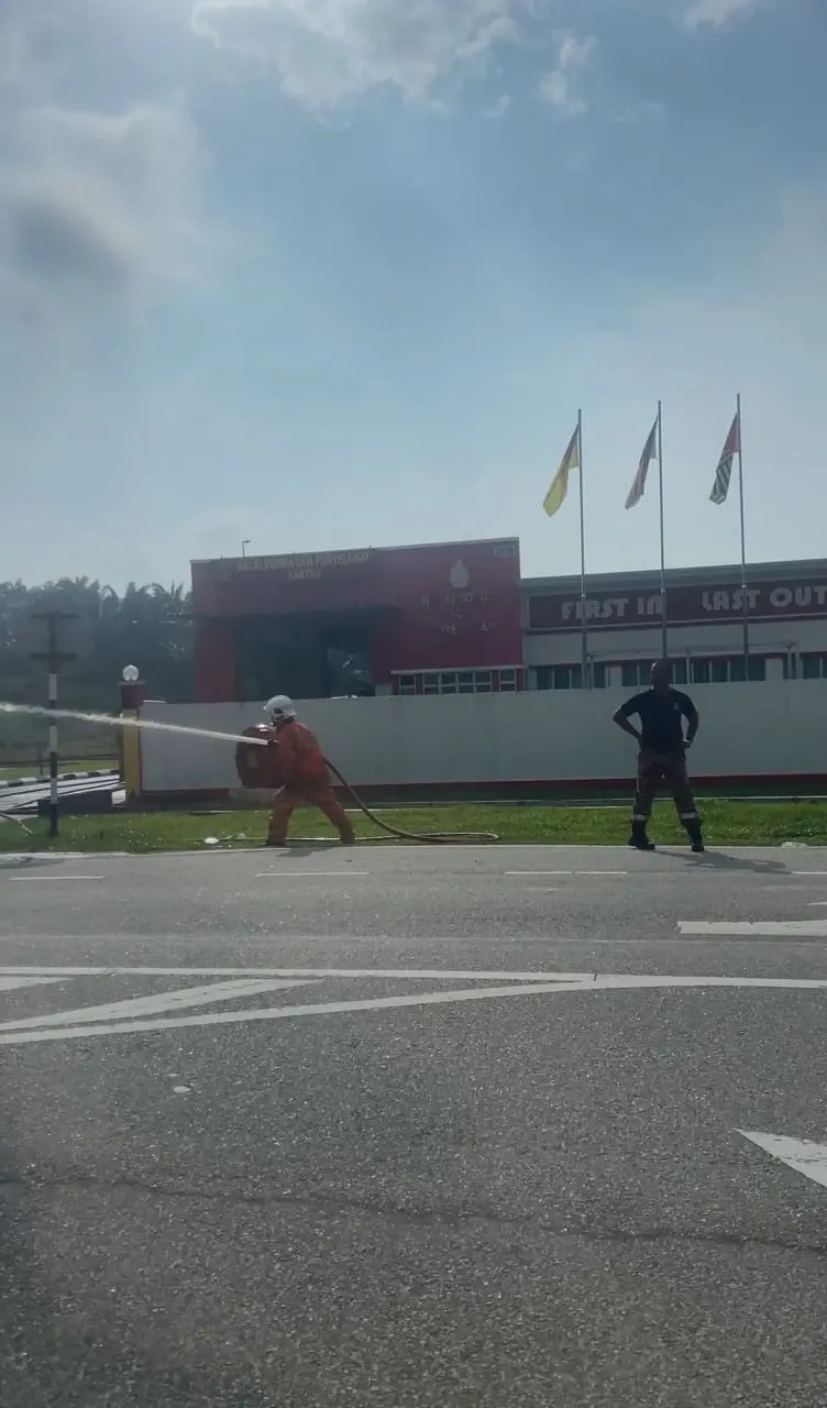 firefighter spraying water at each other
