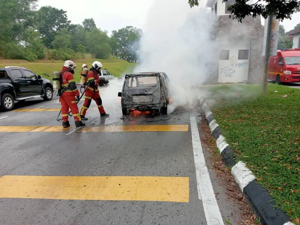 Firefighters putting out burning car in Bangi