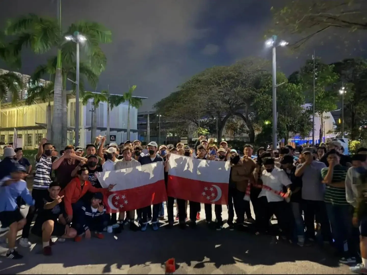 Football fans hold SG flag upside down