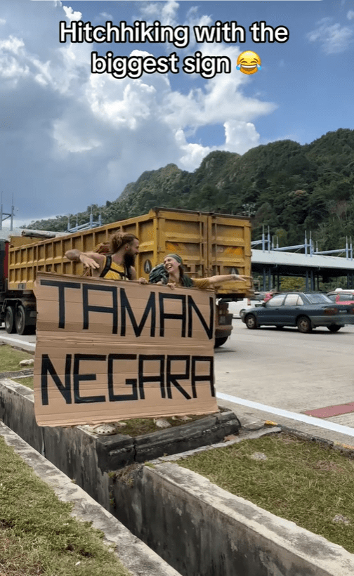 Foreign couple holds giant 'Taman Negara' sign