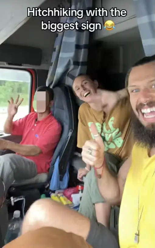 Foreign couple poses with M'sian lorry driver