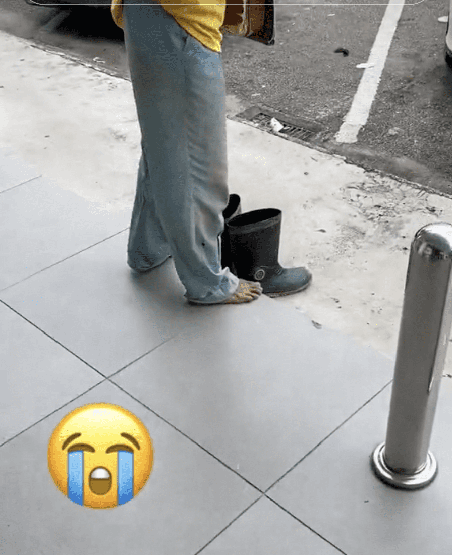 Foreign Worker removes shoes at ATM 03