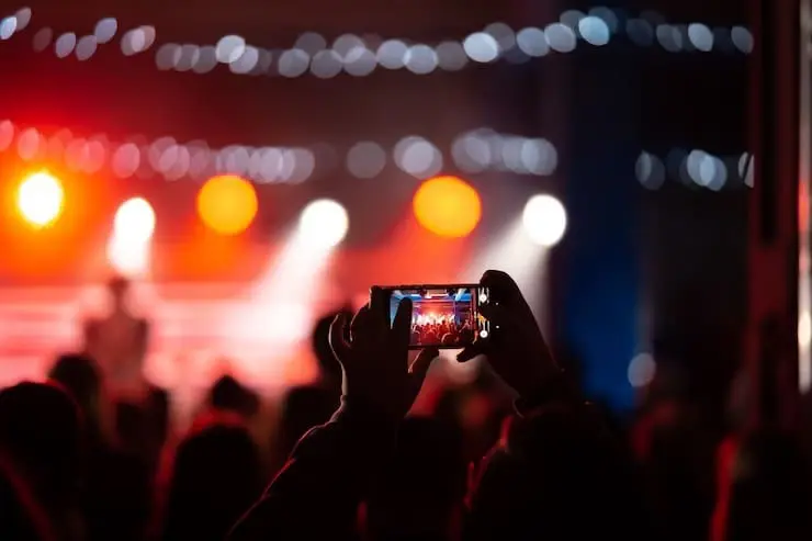 Man taking picture of a concert 