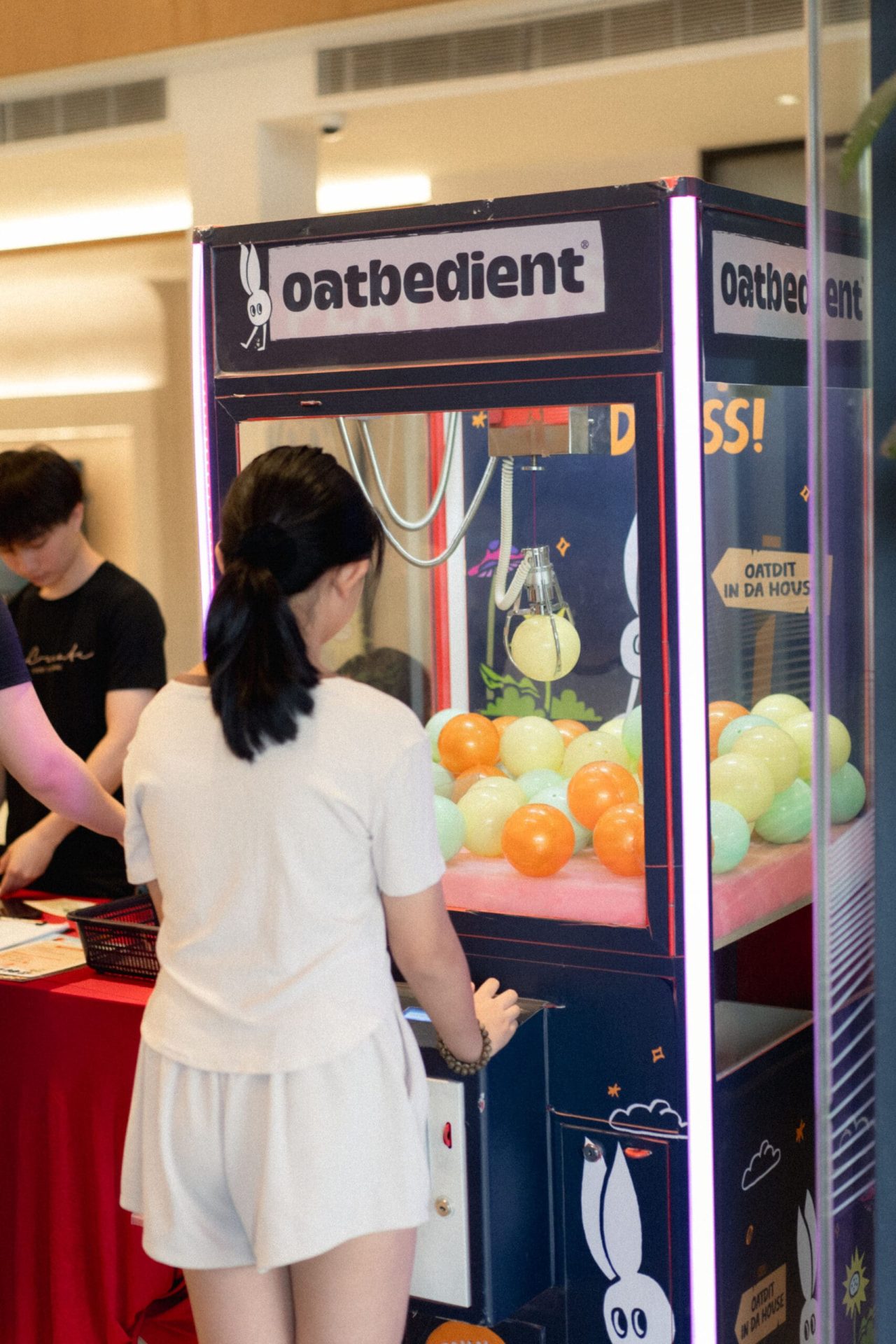 girl playing claw machine game