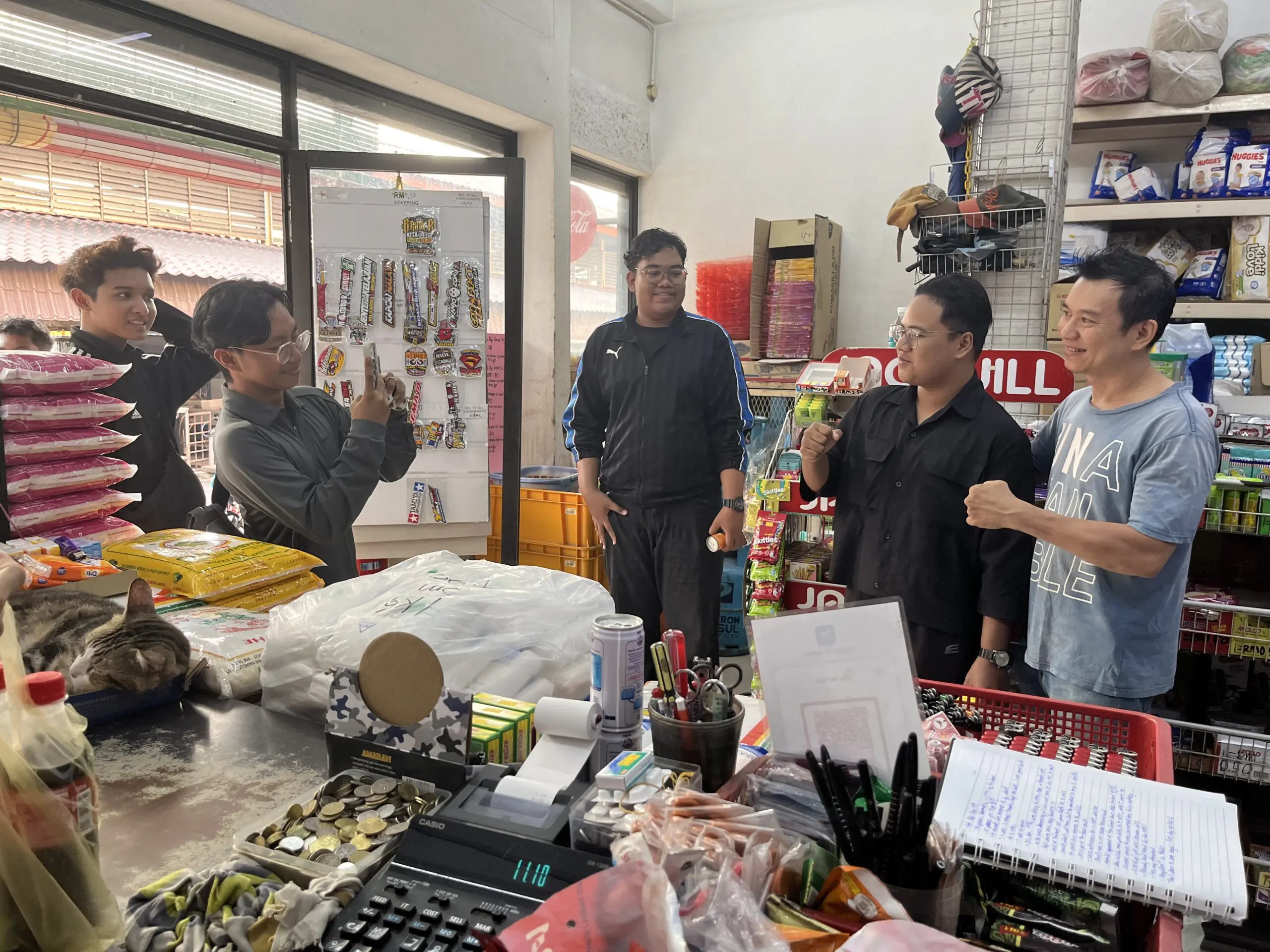 Goh posing with customers