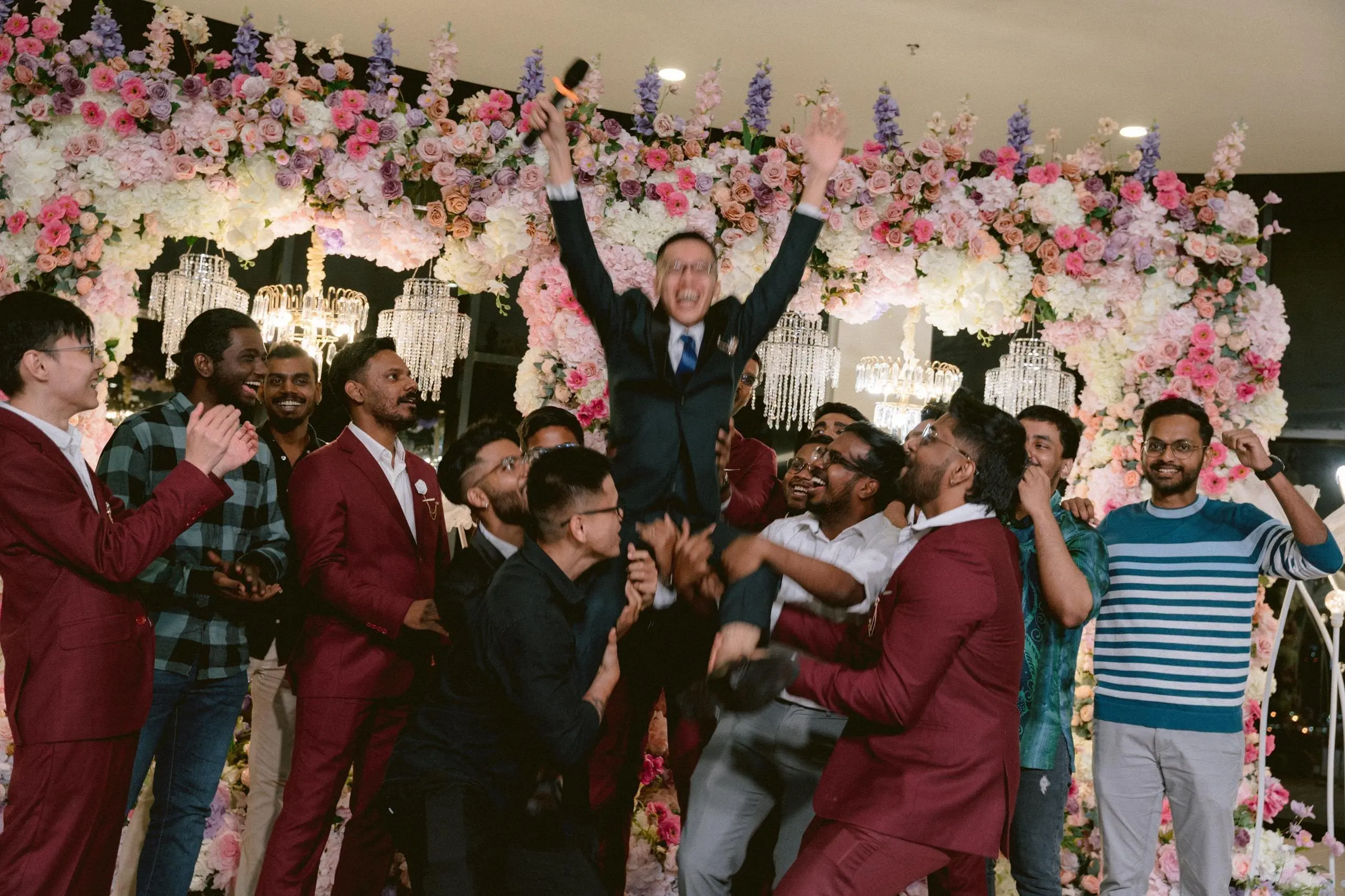 groomsmen carrying nicholas at their wedding