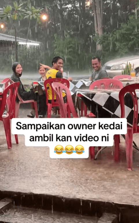 Group of M'sians smile while getting soaked in the rain