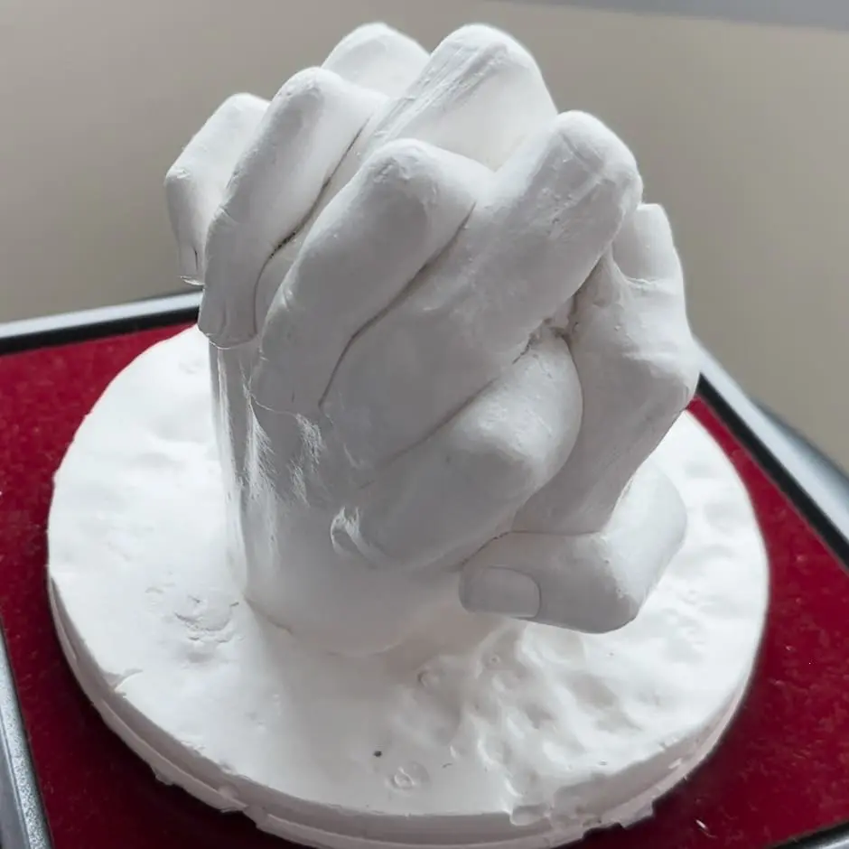 Completed hand cast mould of Yiu holding his wife's hand