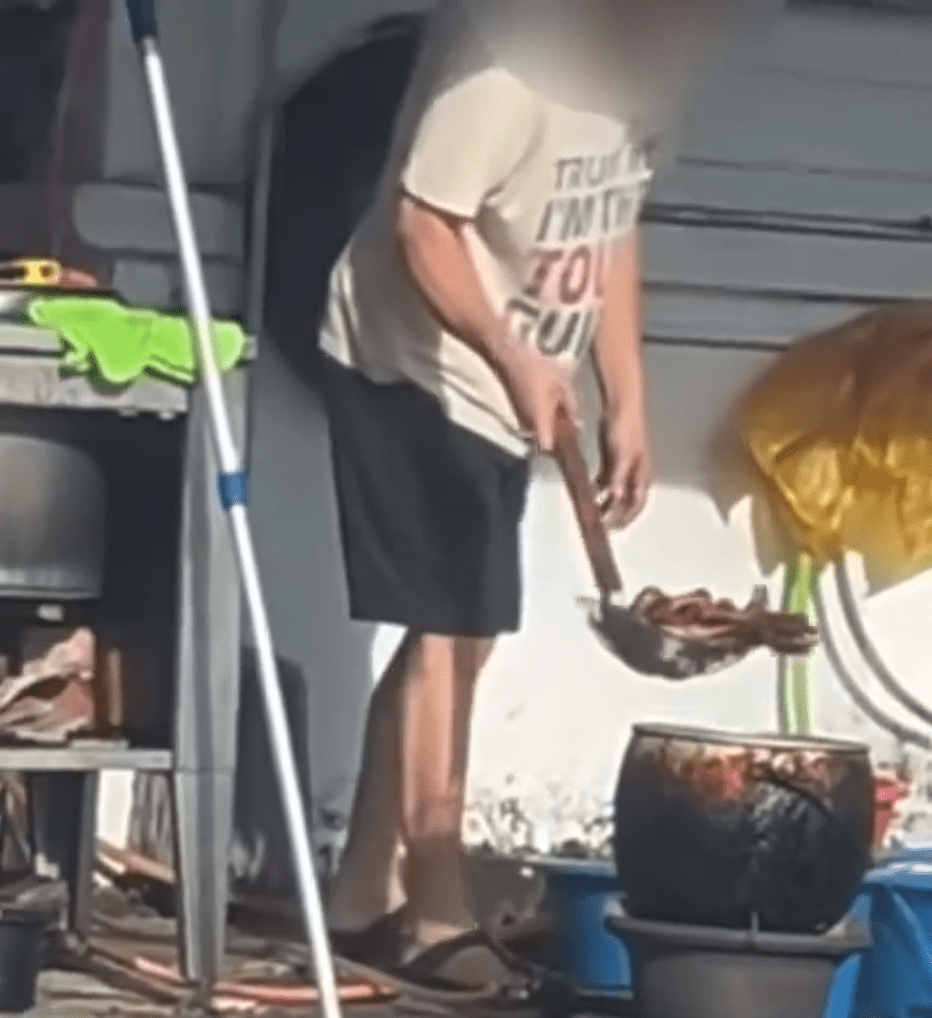 Hawker transfers chicken feet to metal pot