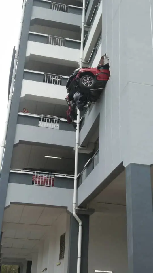 Honda hanging off from parking lot in Serdang
