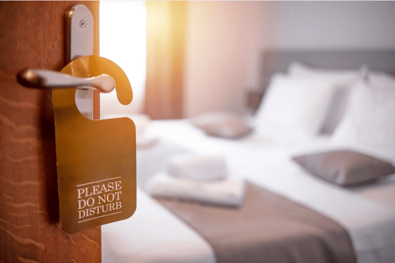 Hotel door with 'do not disturb' sign