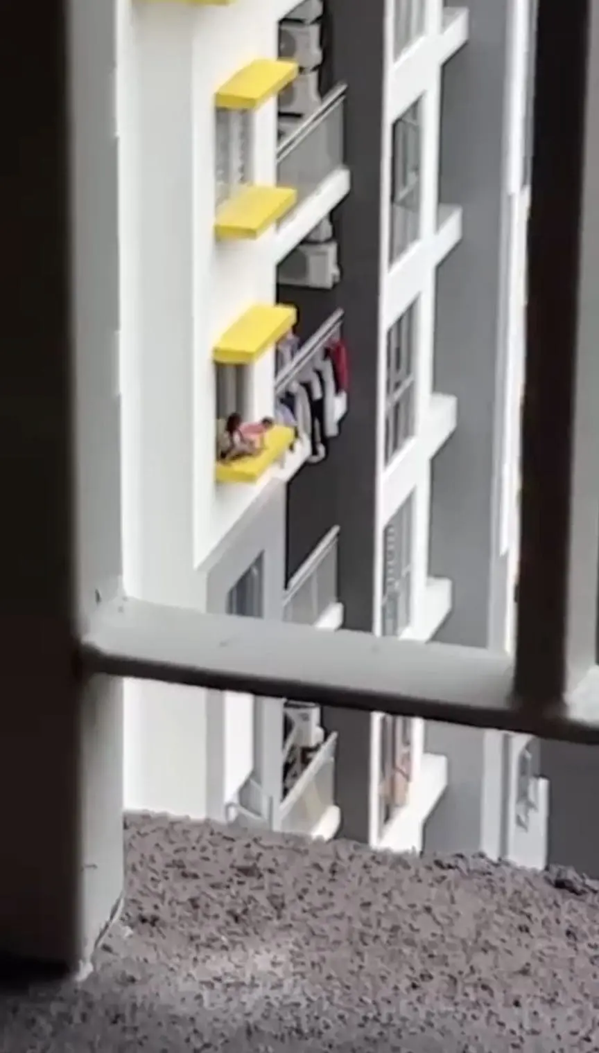 Kids playing on windowsill of high-rise condo in KL