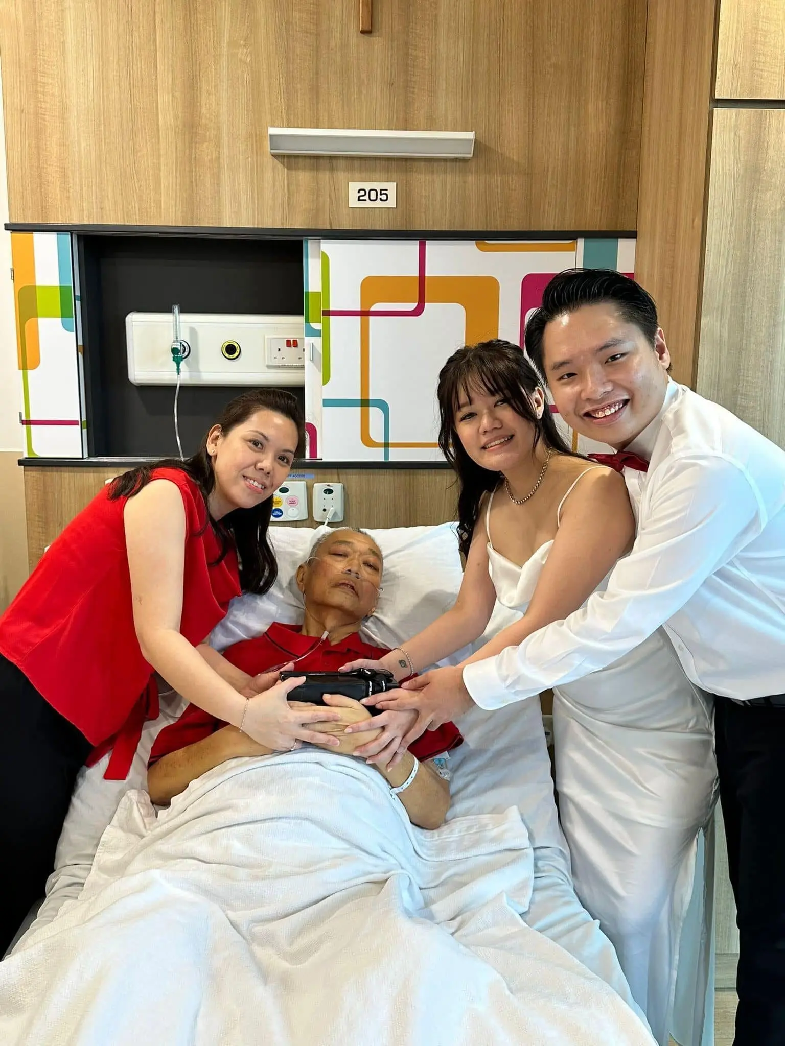 Phoebe and Marcus take a photo with parents