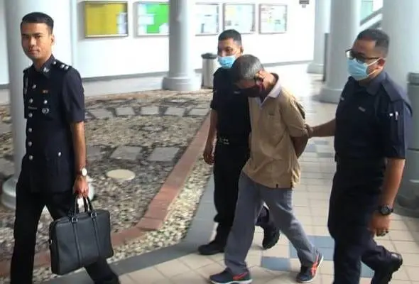 Aziz Tambi escorted by police