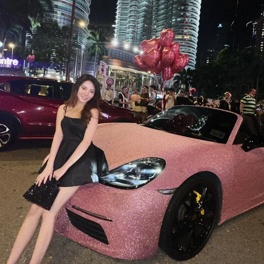Jun Jun posing with her Porsche