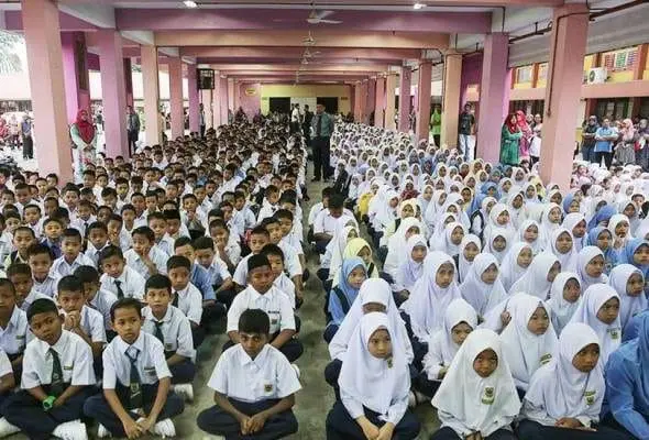 Malaysian students sitting on the floor