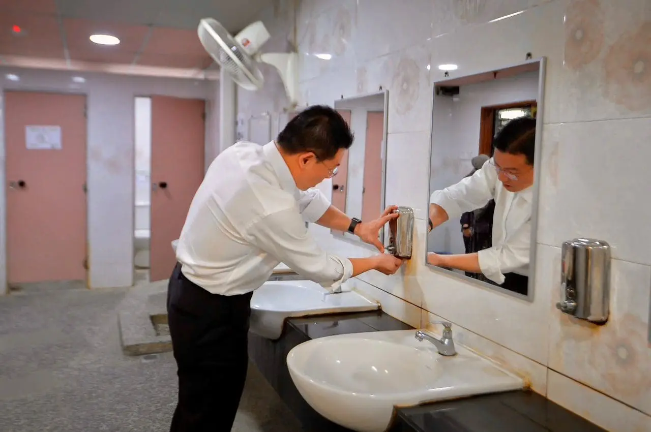 Nga Kor Ming inspecting a public toilet