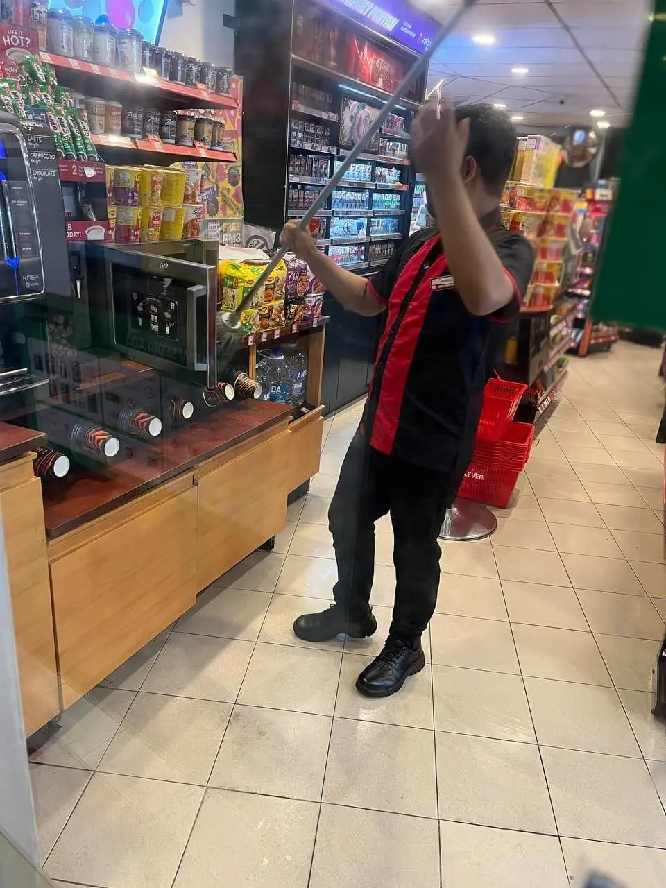7-Eleven staff cleans microwave with mop
