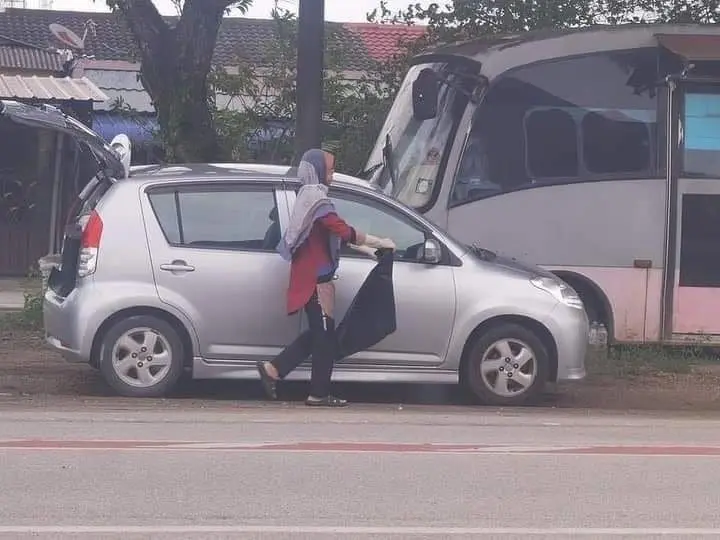 Terengganu woman approaches dog carcass