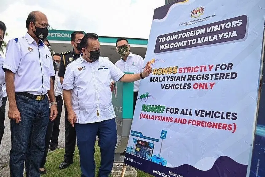 Alexander Nanta Linggi looking at a board about RON95 petrol