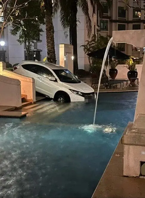 Carpooling Gone Wrong: E-Hailing Driver Accidentally Drives Into Swimming Pool Amid Heavy Downpour