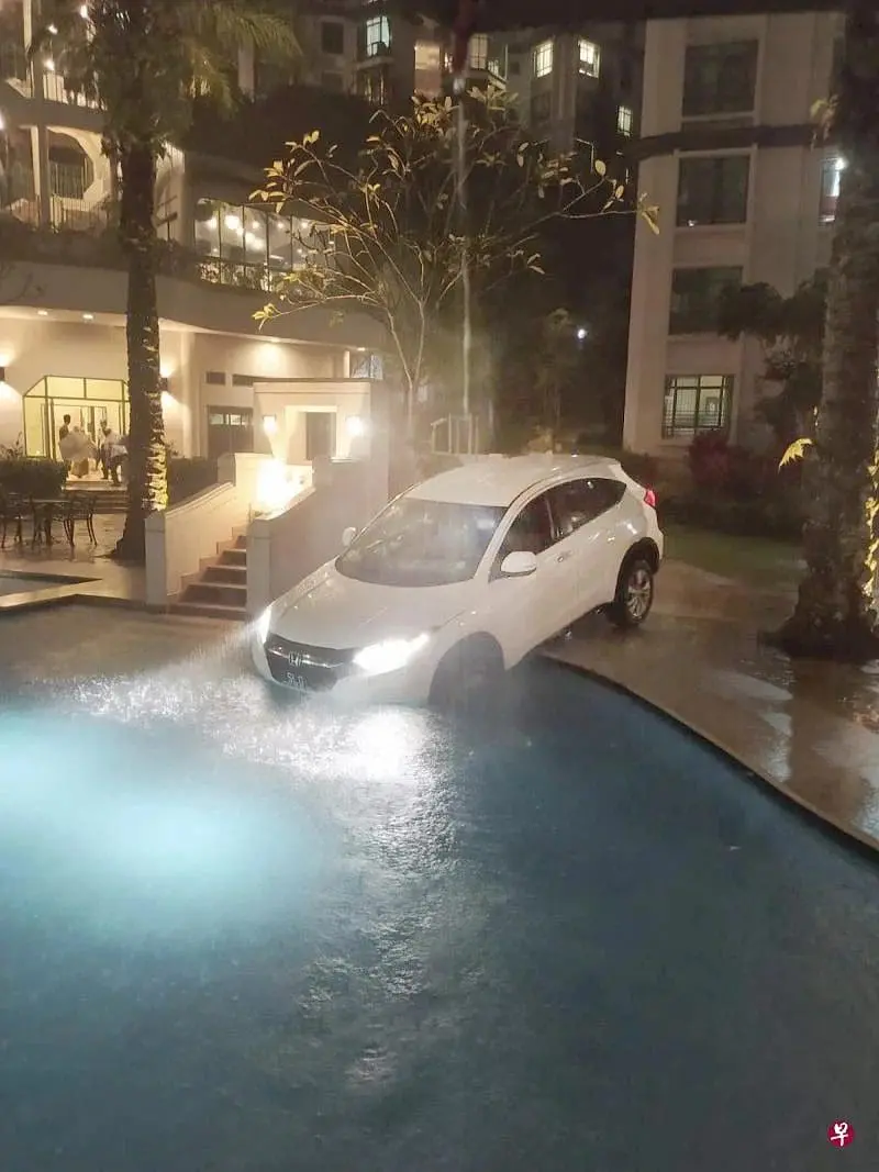 Carpooling Gone Wrong: E-Hailing Driver Accidentally Drives Into Swimming Pool Amid Heavy Downpour