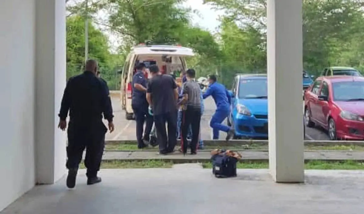 Paramedics at the scene of apartment where M'sian student fell