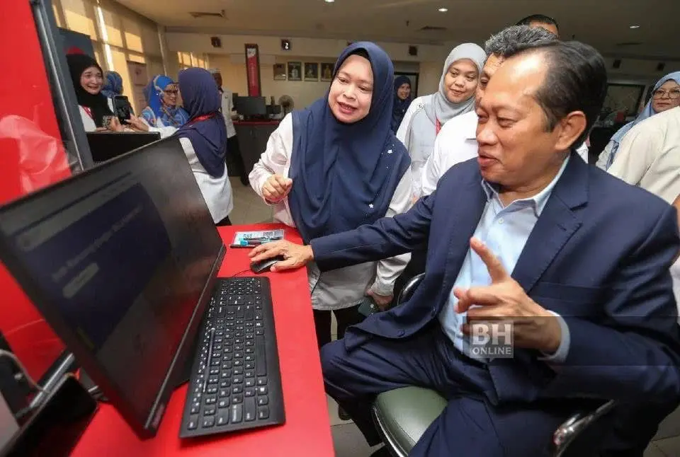 Ahmad Maslan in front of computer