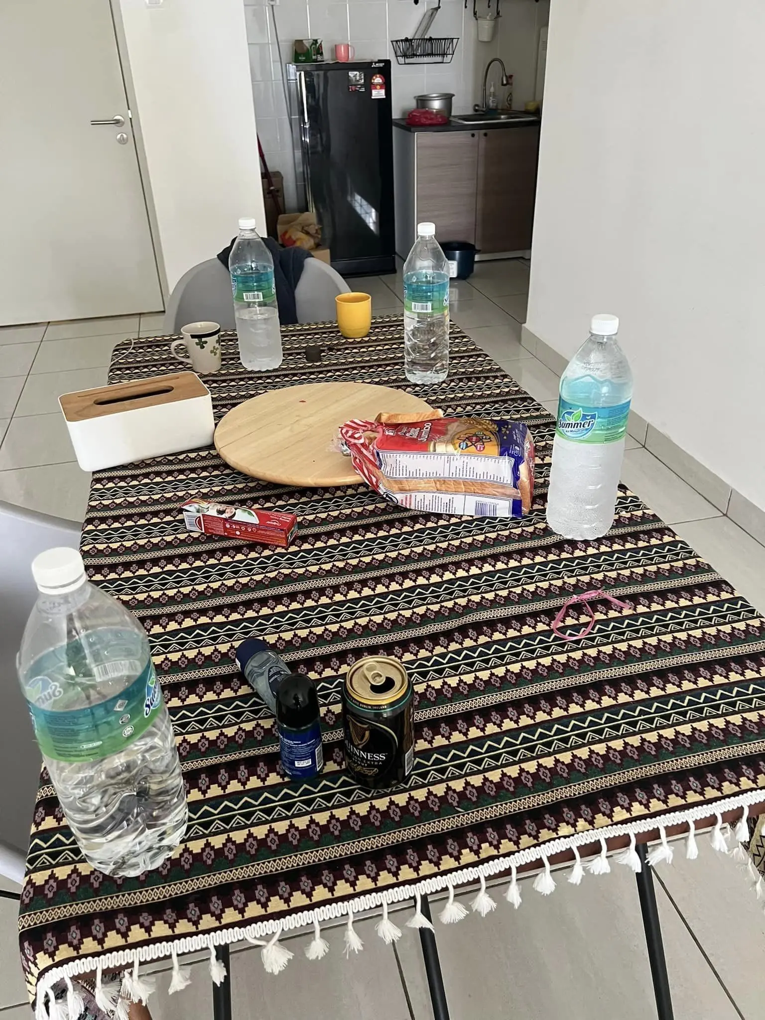 Beer, cigs, water bottle, bread left on top of the table at Airbnb