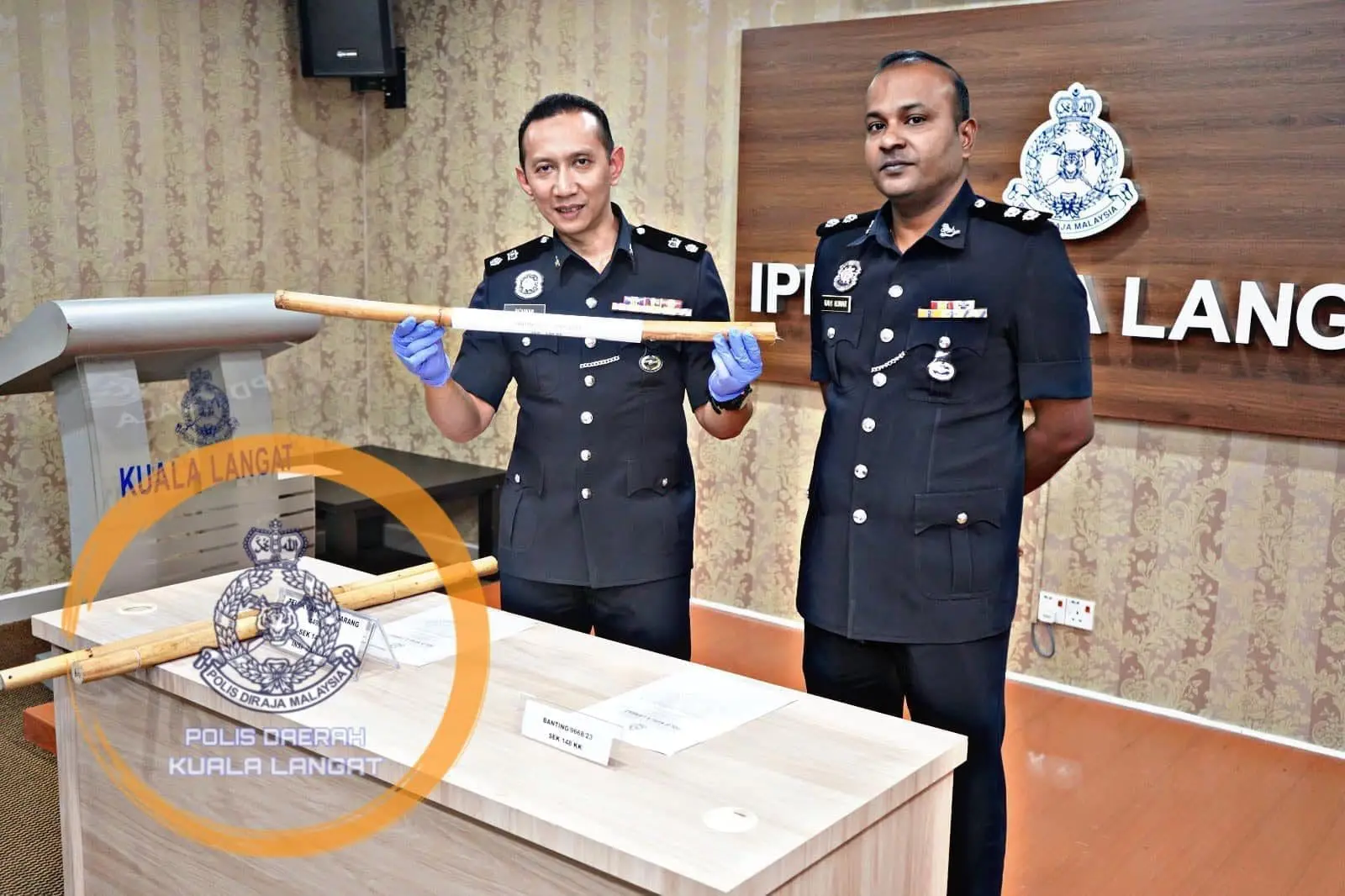 Kuala Langat police officers showing wooden stick