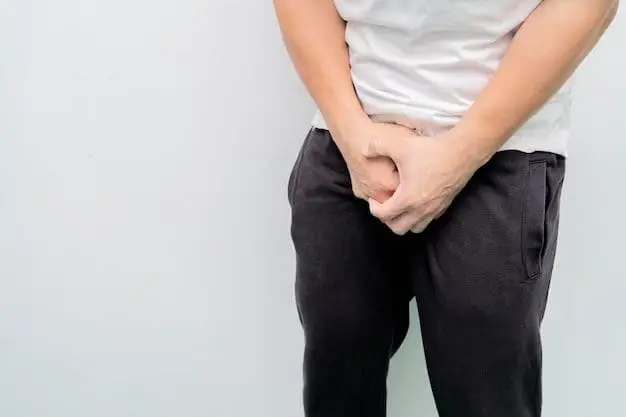 Man holding his crotch with his two hands