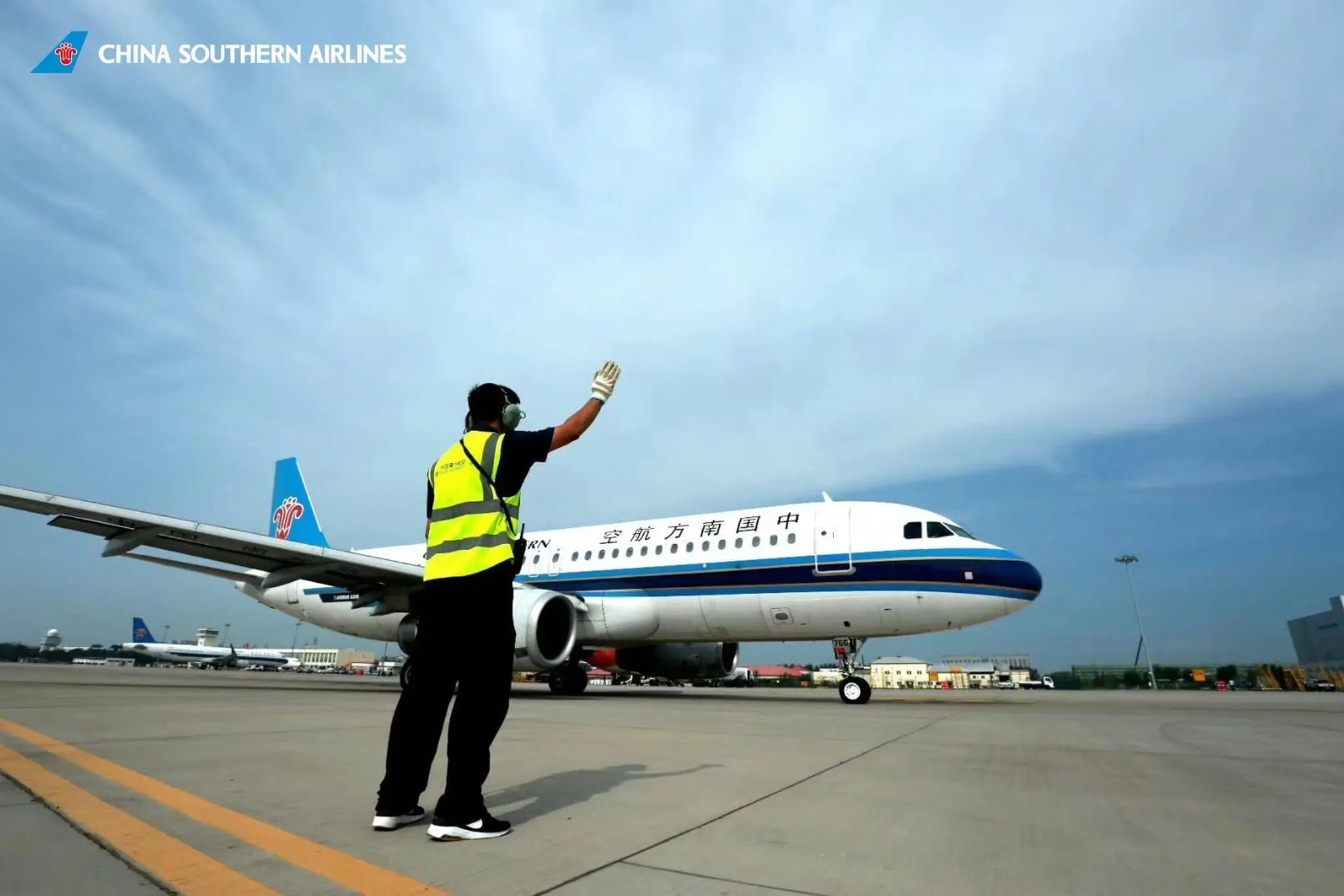 China Southern Airlines staff guiding plane