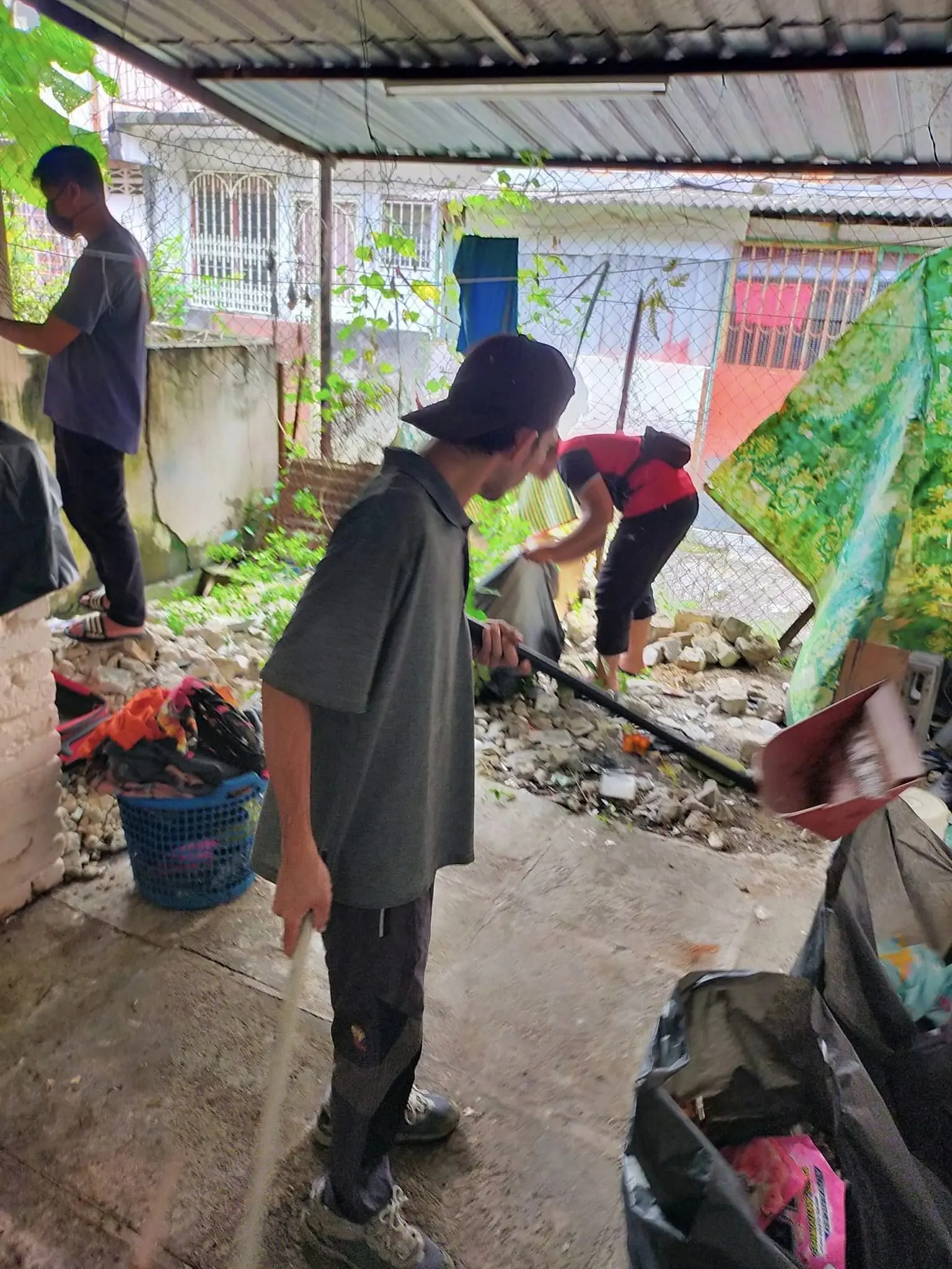 Group of men cleaning up back kitchen area