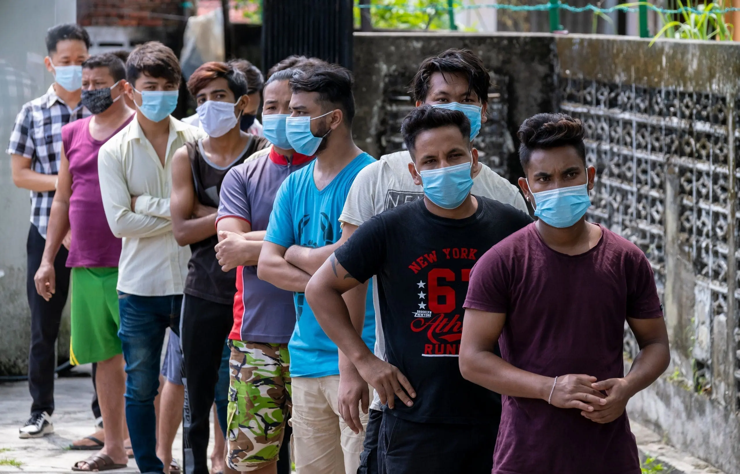 Foreign workers standing in line