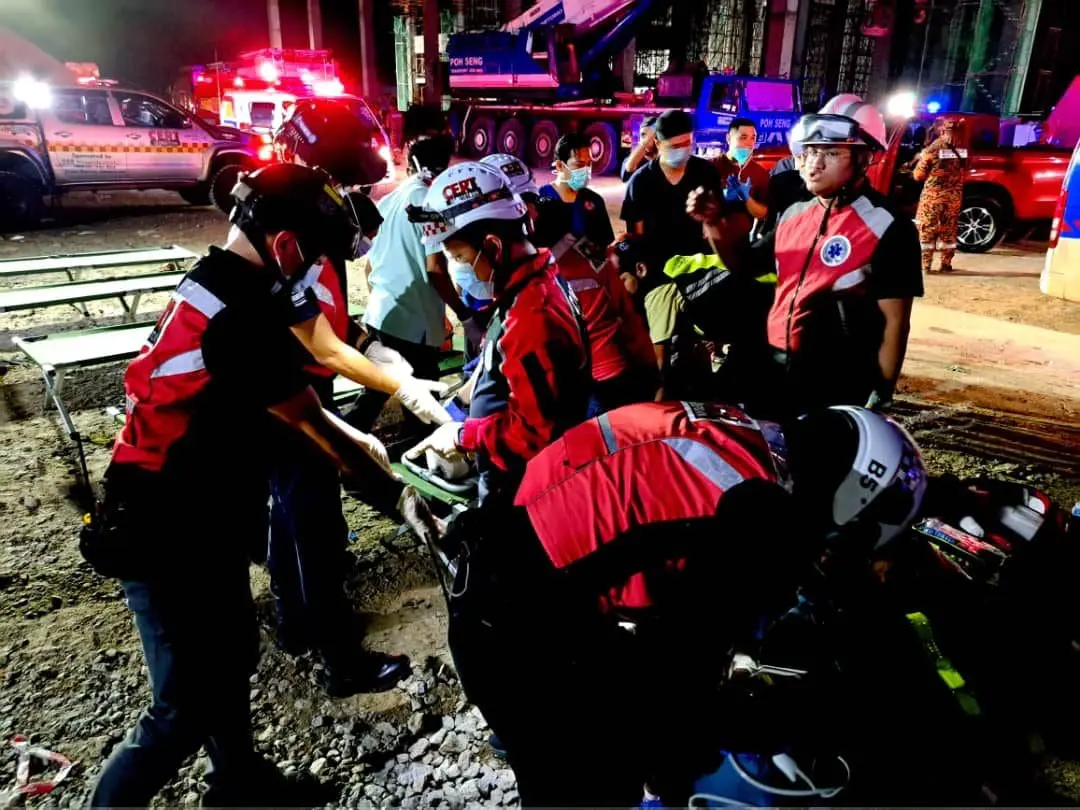 Rescuers helping victims after building collapses in Penang