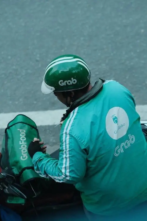 Grab rider in uniform and helmet