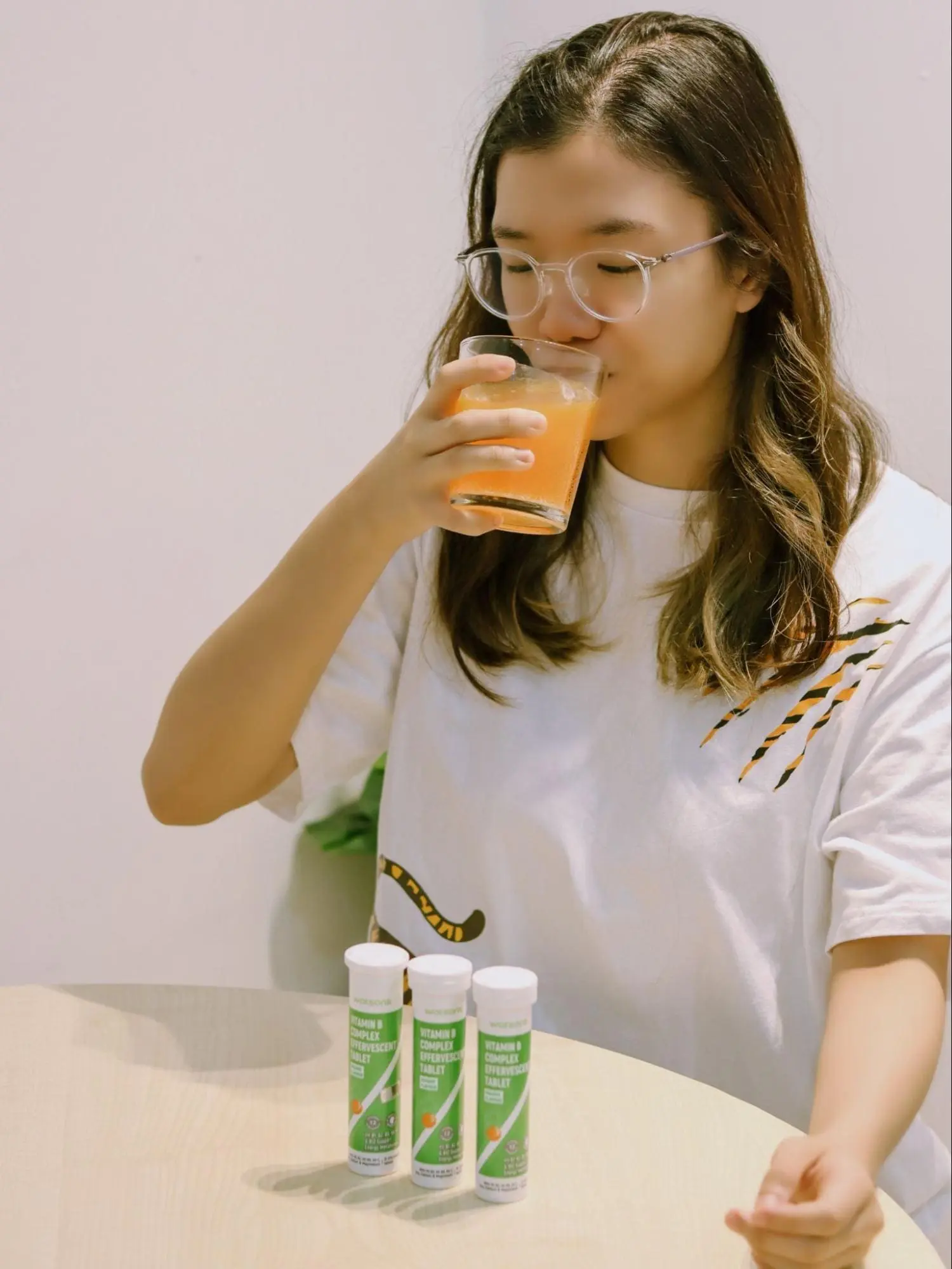 Asian woman consumes Watsons Vitamin B