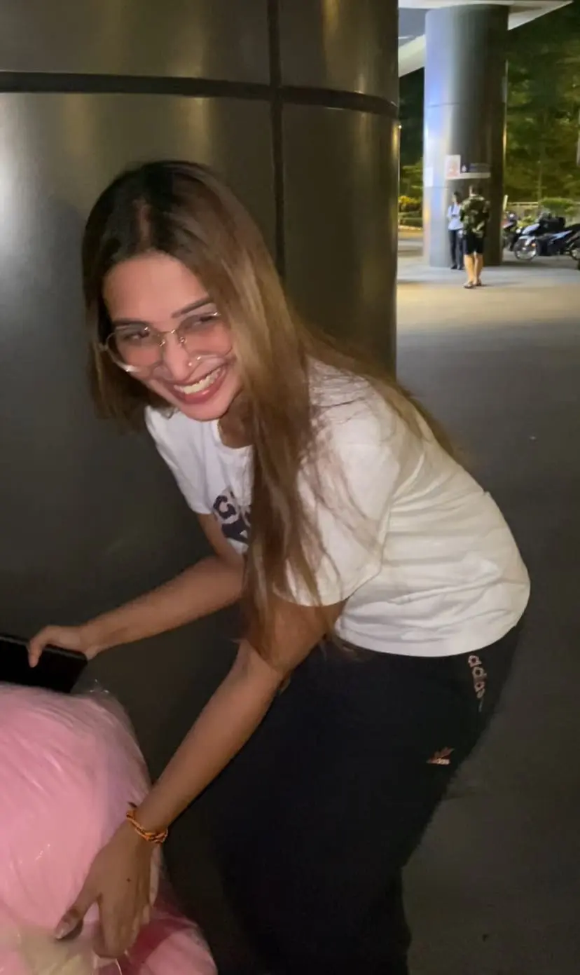 woman holding a pink teddy bear