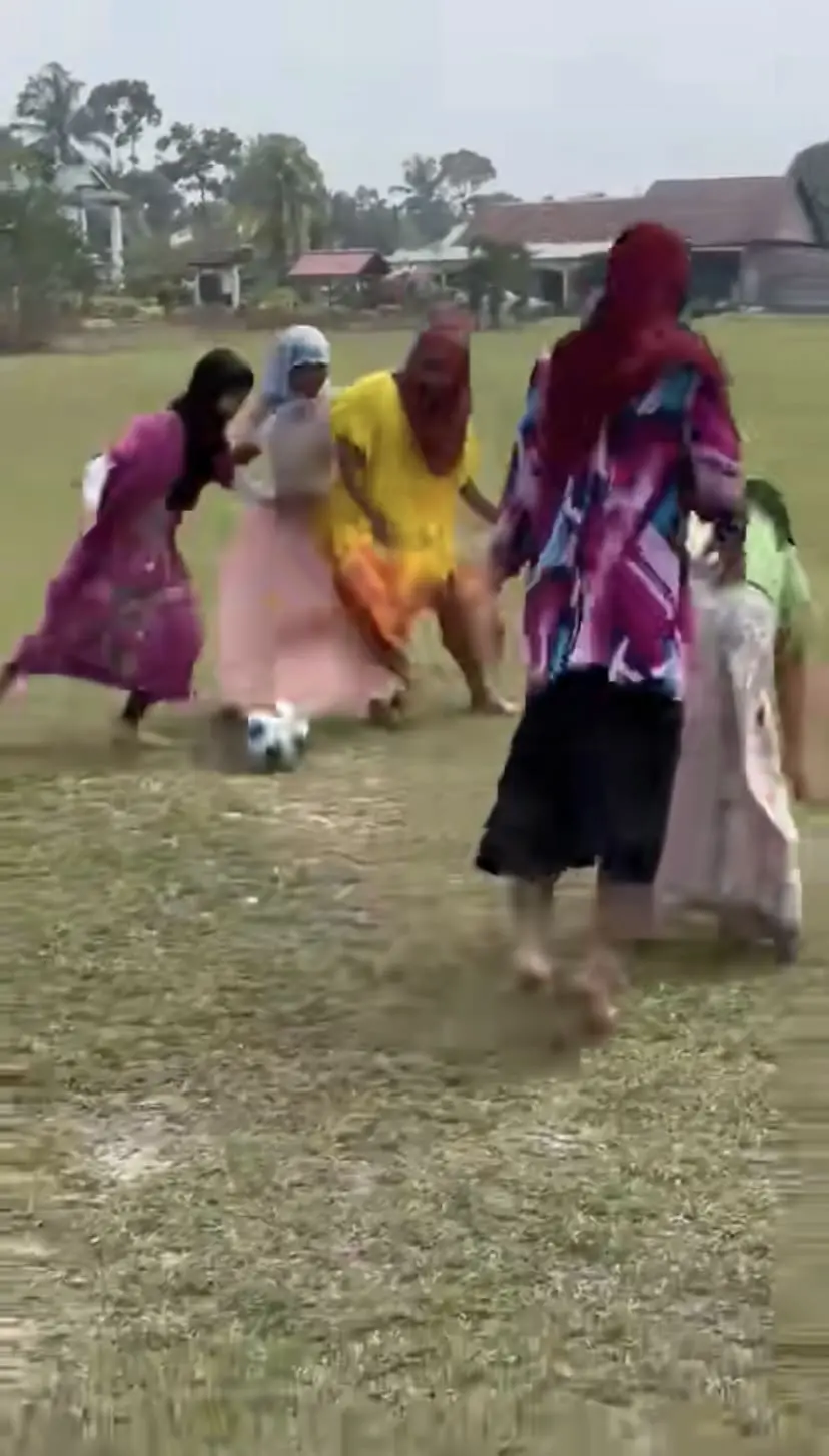 Boys in baju kelawar playing football