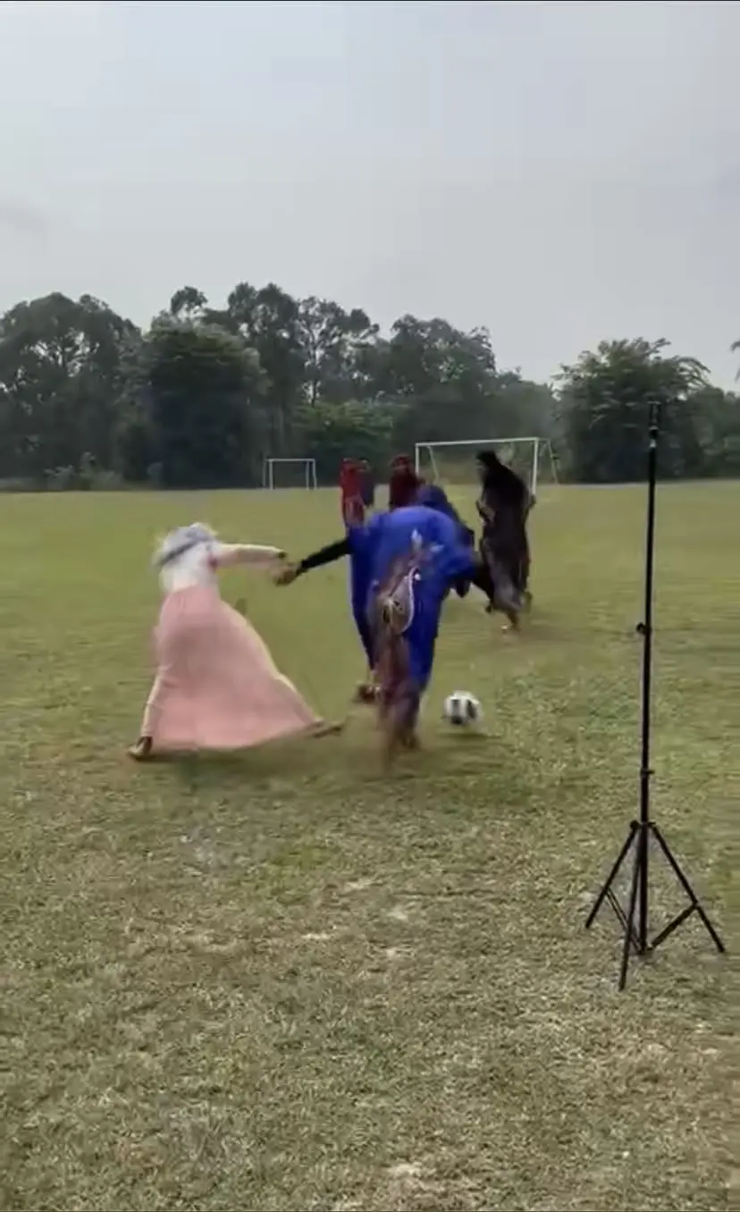 Boys playing football in baju kelawar