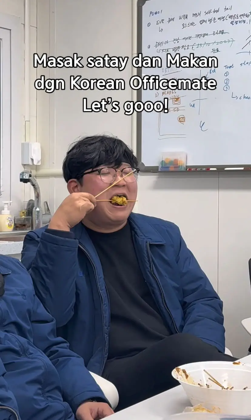 korean man enjoying satay