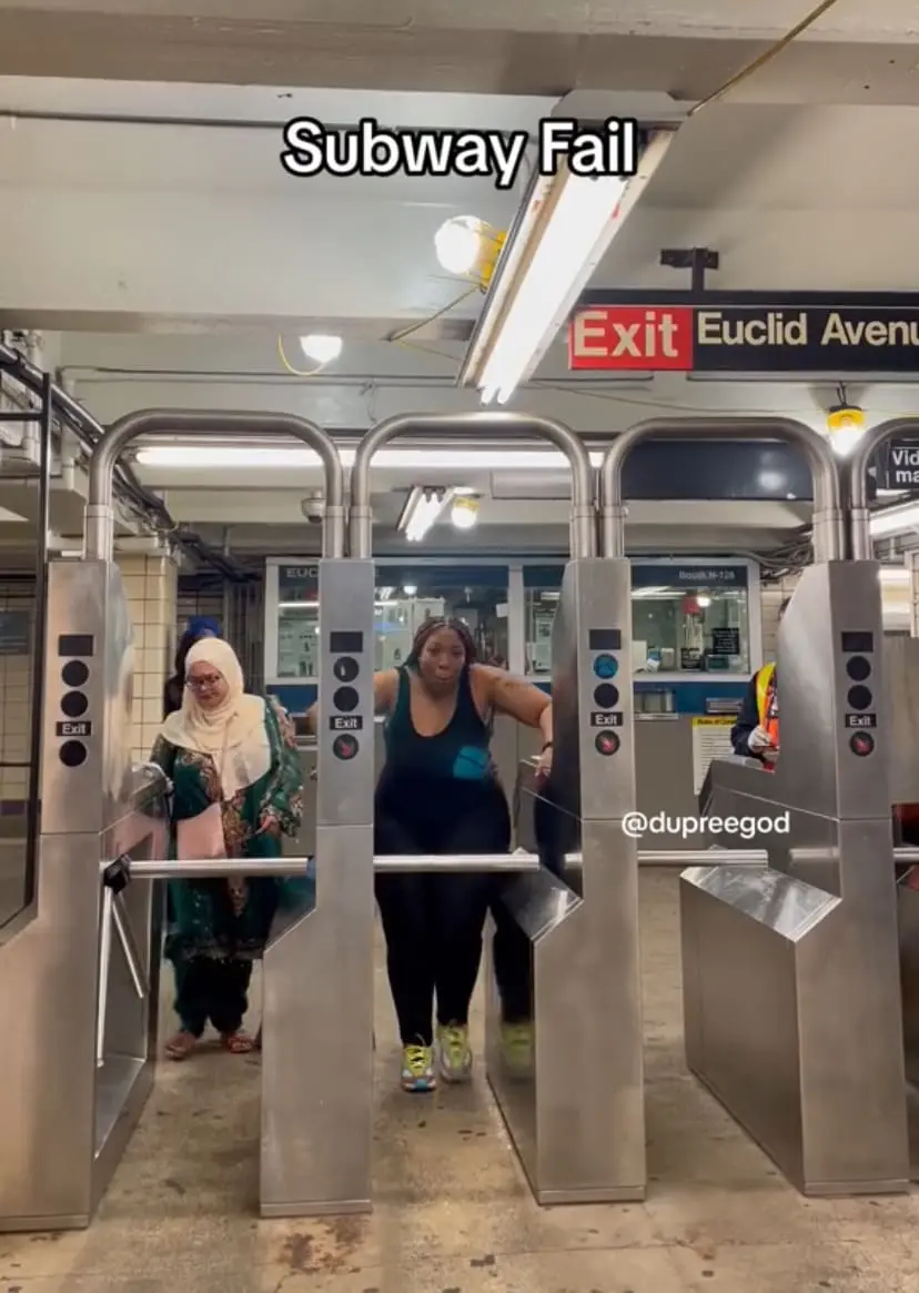 muslim woman and American at the subway's turnstile