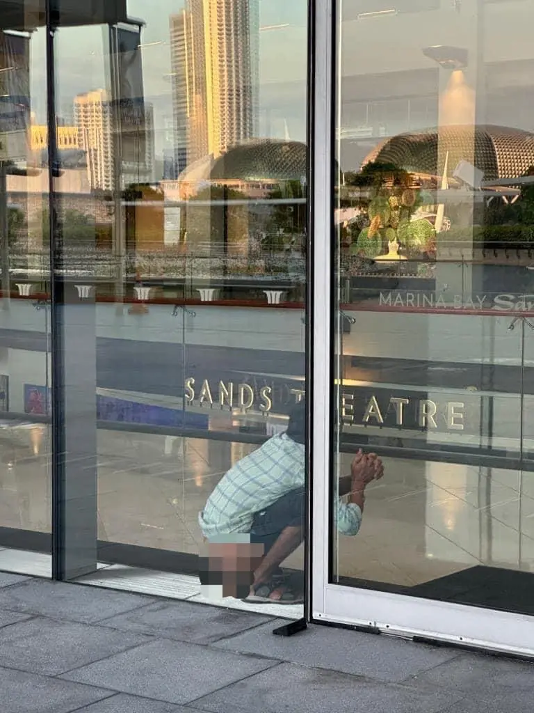 Man pooping at Marina Bay Sand