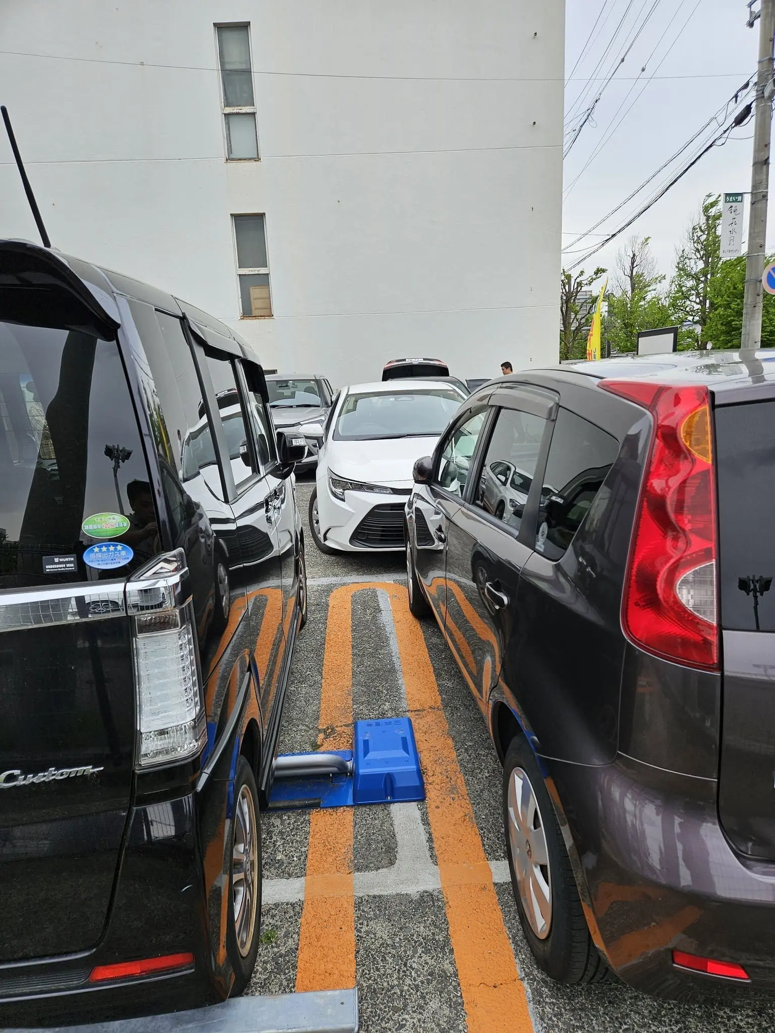 car double parked by M'sian in Japan