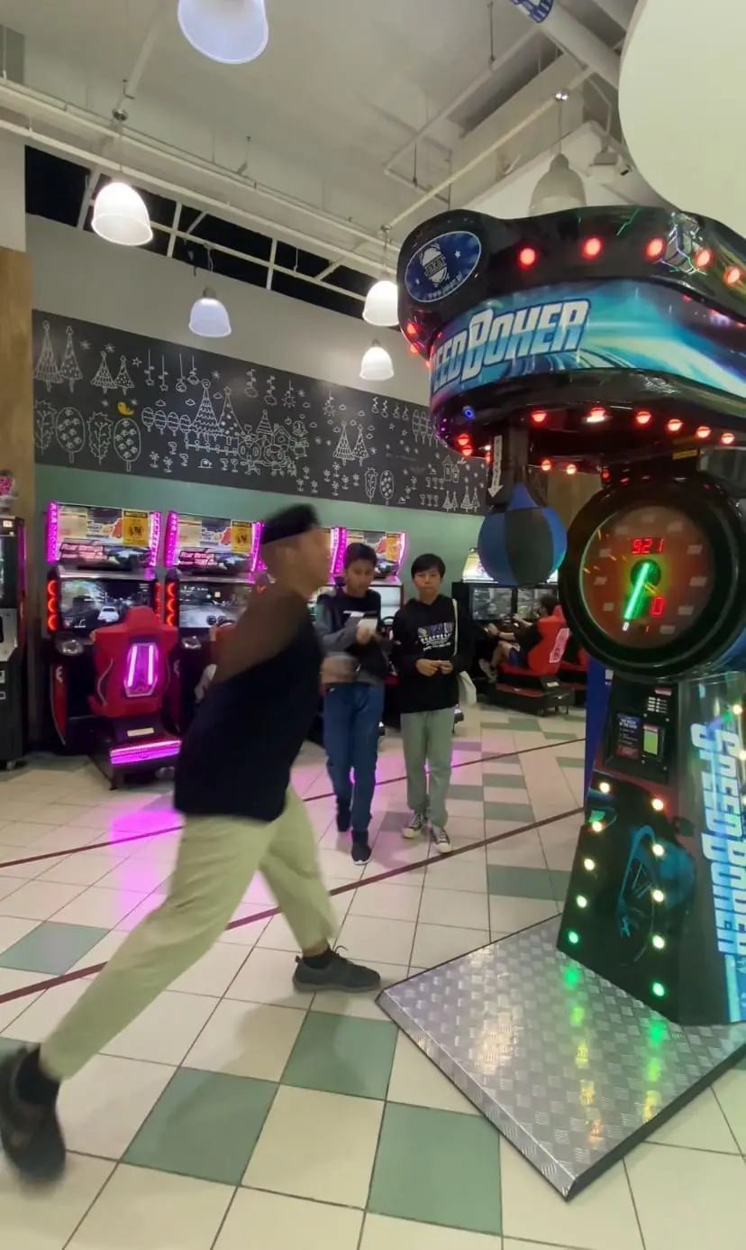 Two kids come closer to the boy who tries to punch