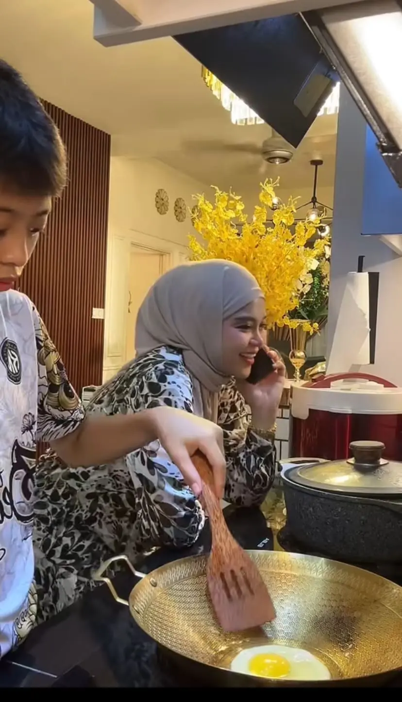 Mum and son in the kitchen with phone on her hand 