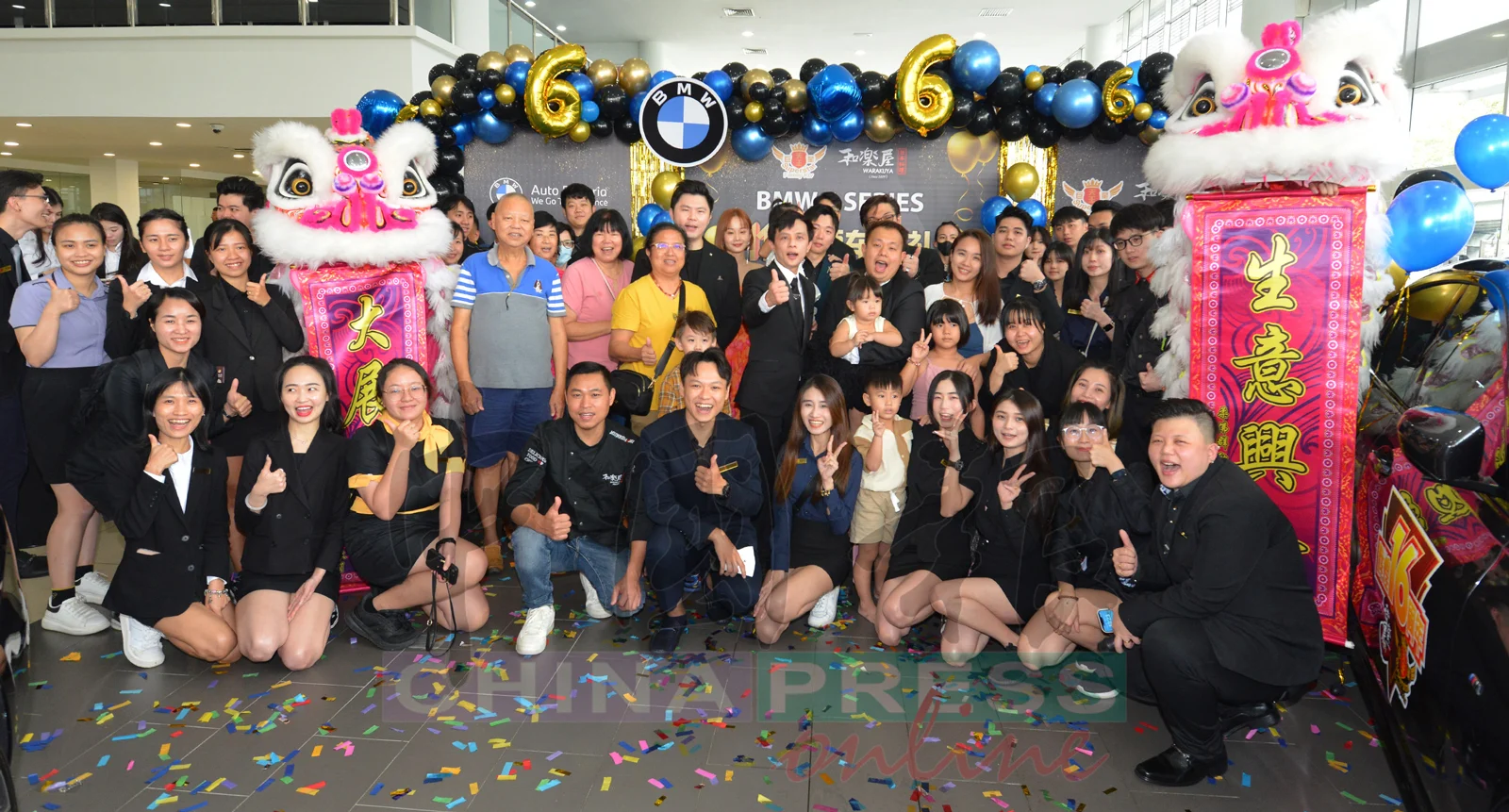 John Wong taking a photo with employees