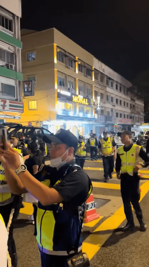 JPJ officers take photos of youths doing squats
