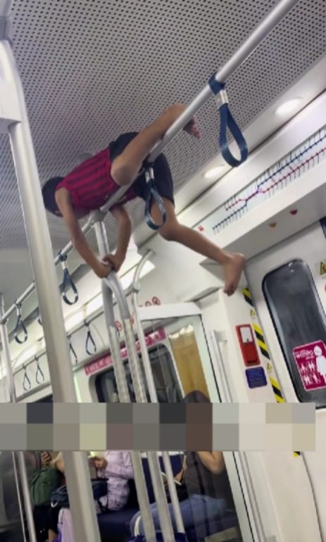 kid lying on the pole of moving ktm